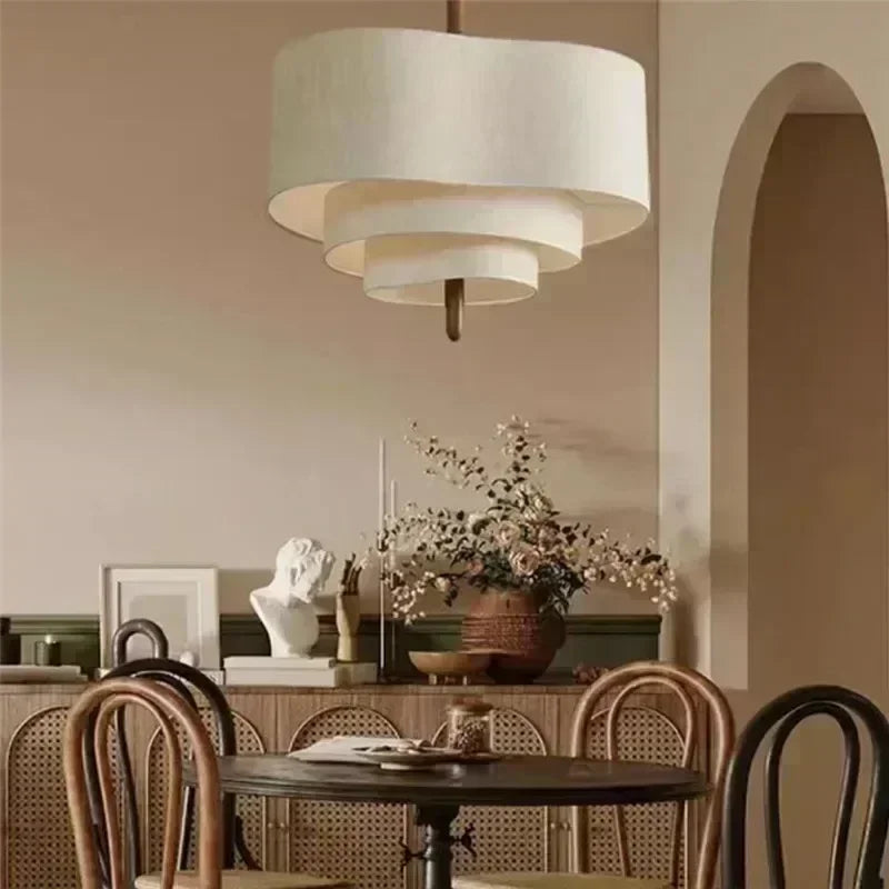 Dining room with a round table, chairs, and a large pendant light.
