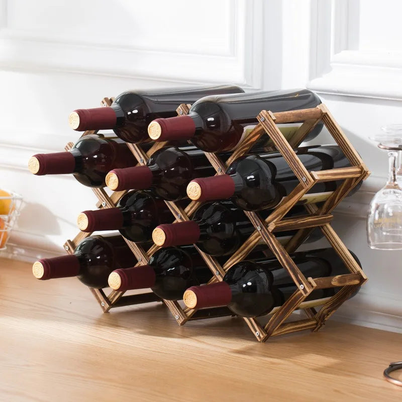 Wooden wine rack holding bottles of red wine on a wooden surface.